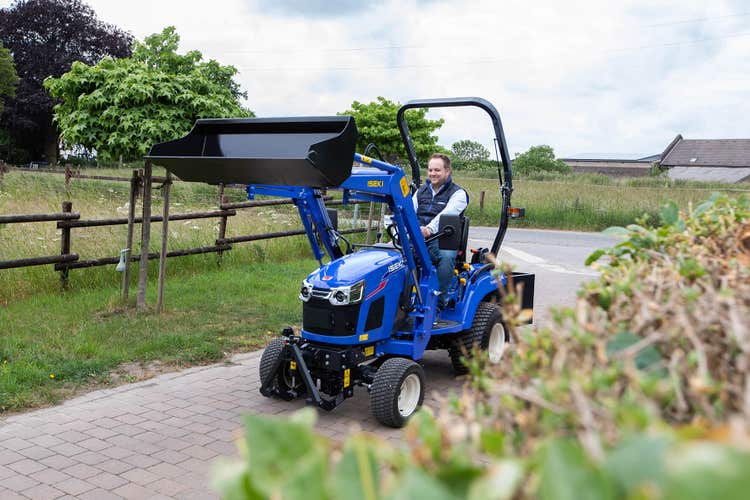 Mann fährt mit Iseki TXGS 24 Traktor auf Weg